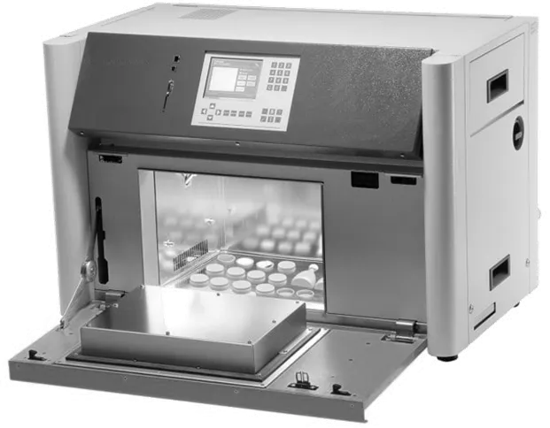 Benchtop light exposure cabinet with a keypad display and an open door showing sample bottles inside